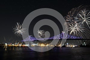 Colorful fireworks explode over bridge. MontrealÃ¢â¬â¢s 375th anniversary. luminous colorful interactive Jacques C